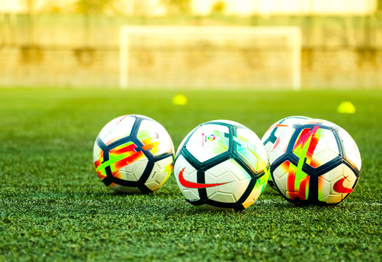 Soccer balls on the pitch